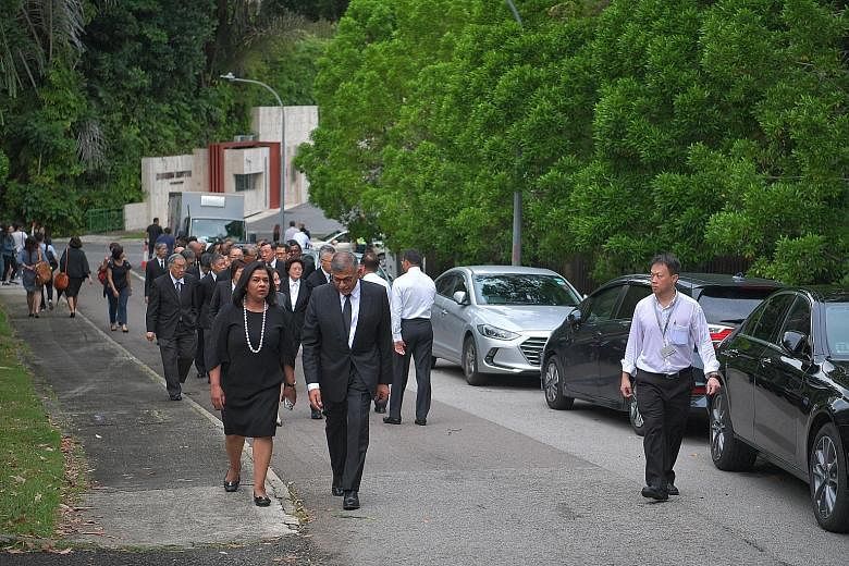 Chief Justice Sundaresh Menon arriving at the wake with his wife. He described Mr Yong as having "a wonderful heart for the people who worked with him". Ms Phyllis See (centre, in white), speaking to reporters at the wake yesterday. Ms See, 71, was s