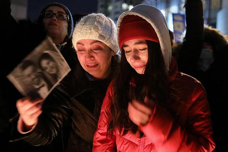 Mourners attending an outdoor vigil for the victims of the doomed flight on Thursday. PHOTO: REUTERS