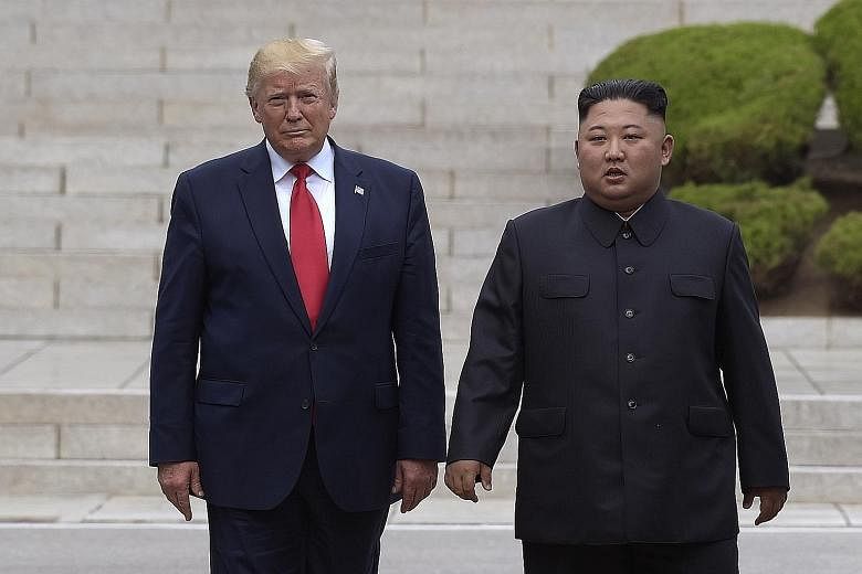 A file photo taken on June 30 last year showing US President Donald Trump with North Korean leader Kim Jong Un on the North Korean side of the border at the village of Panmunjom in the Demilitarised Zone.