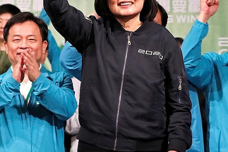 Taiwan's President Tsai Ing-wen, who won 57 per cent of the votes, acknowledging supporters outside the Democratic Progressive Party headquarters in Taipei after her victory yesterday. &#9621;