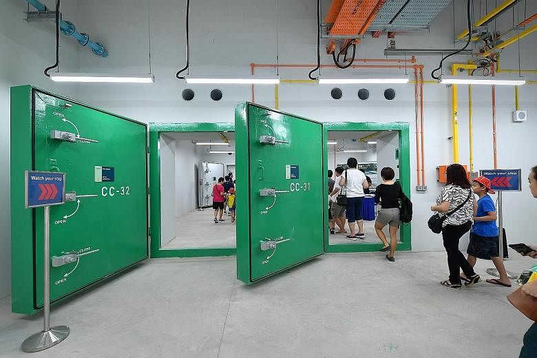 Left: The civil defence shelter has hardened boundary walls, and floor and roof slabs built from reinforced concrete. Above: Transport Minister Khaw Boon Wan at the decontamination chamber of the Woodlands MRT station civil defence shelter yesterday.