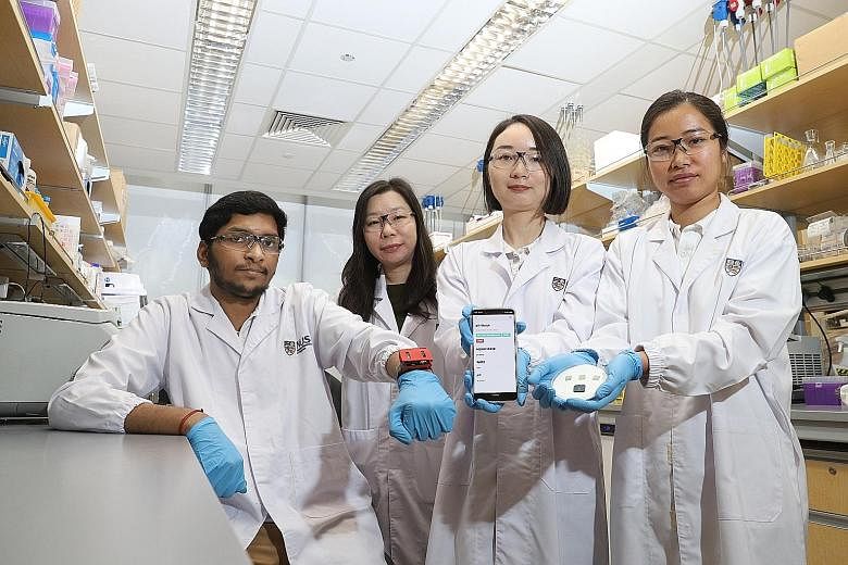 (From left) Doctoral student Ananta Narayanan Balaji, wearing the pH Watch, with Assistant Professor Shao Huilin, Dr Wang Bo and doctoral student Chen Yuan, who is holding the pulse oximeter and pH sensor. The team of researchers from the National Un