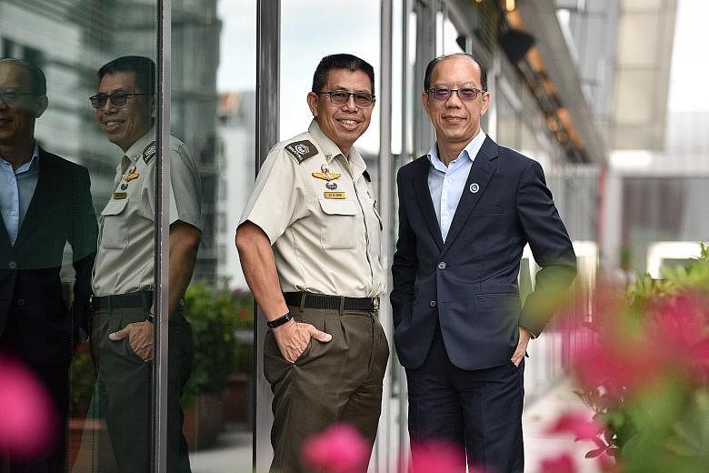 Master Warrant Officer Chia Mui Sowe (left), 54, and Colonel (Retired) Lai Hing Nam, 53, are recipients of the bond-free Singapore Management University Warriors Scholarship.