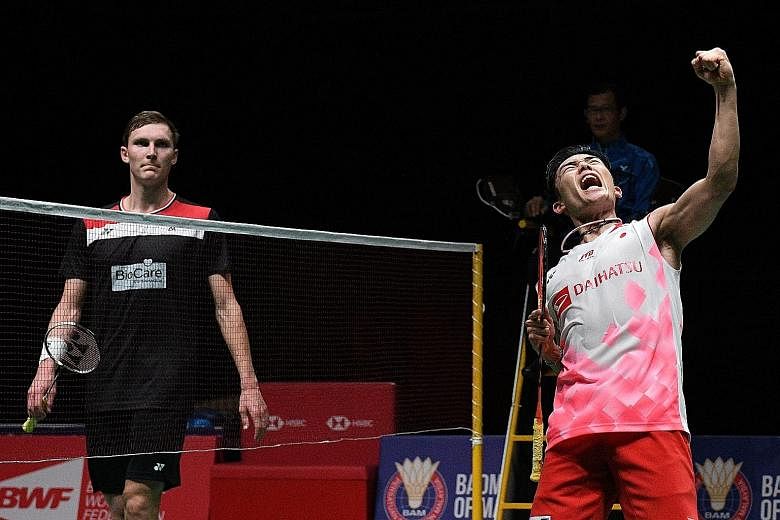 Kento Momota punching the air after sealing victory in the Malaysia Masters final against a despondent Viktor Axelsen. The Japanese world No. 1's win in Kuala Lumpur was the 13th straight time he had beaten the Dane, dating back to 2014. 