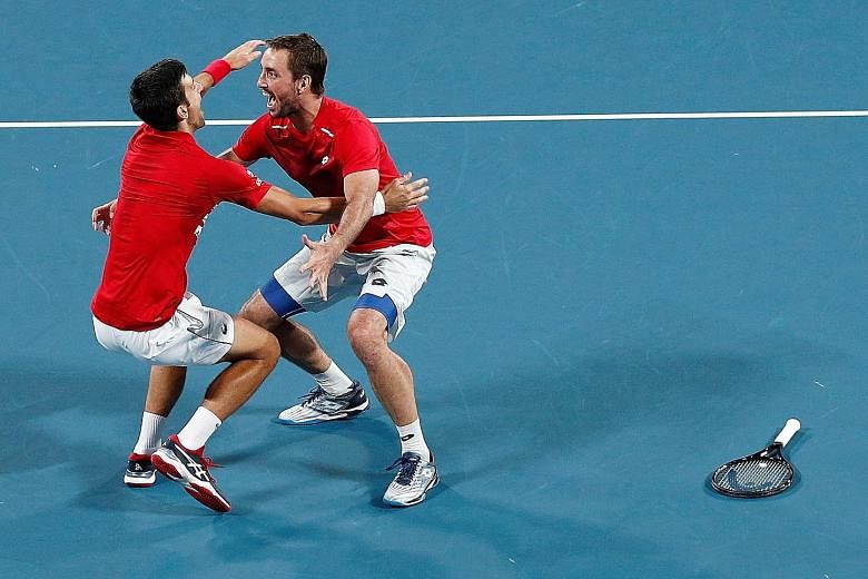 Novak Djokovic and Viktor Troicki celebrating Serbia's ATP Cup victory after winning their doubles match against Spain's Pablo Carreno Busta and Feliciano Lopez. Djokovic did not lose a match in the tournament, earning six singles and two doubles win