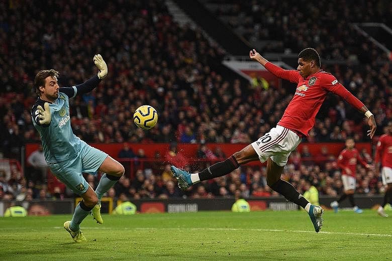 Manchester United striker Marcus Rashford scoring the opener against Norwich's Tim Krul on Saturday. In his 200th game for United, the 22-year-old added a second from the spot to reach 19 goals this season. 