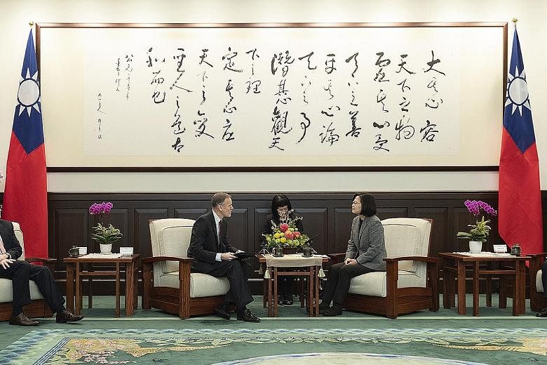 Taiwan President Tsai Ing-wen meeting director of the American Institute in Taiwan William Brent Christensen yesterday, a day after her landslide election victory. While Ms Tsai was widely expected to win, the margin of her victory was fuelled by bot