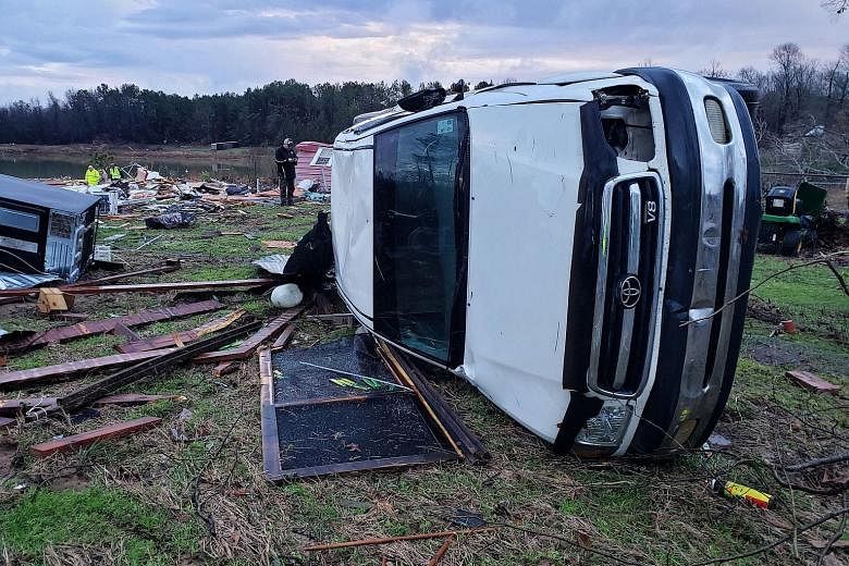 A large vehicle flipped on its side in Bossier Parish, Louisiana, after a tornado with winds of around 217kmh hit the area last Saturday. Severe storms sweeping in the US have killed at least 11 people as high winds, tornadoes and rain battered the c