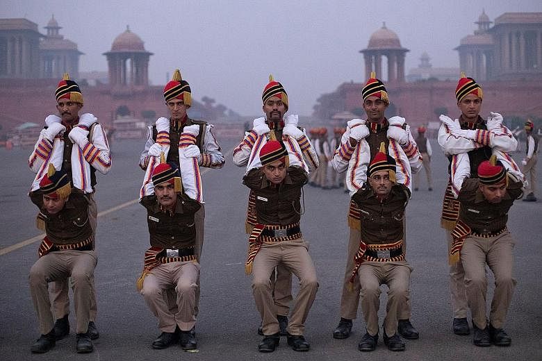 Members of the Delhi Police stretching before a Republic Day parade rehearsal in New Delhi yesterday morning. The police are among the various contingents from different forces preparing for the event. India celebrates Republic Day on Jan 26, to comm