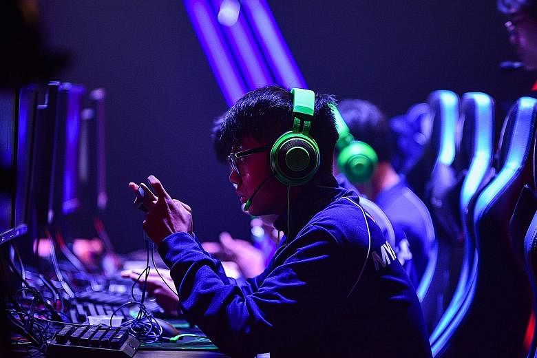 A Myanmar player intently focused on their phone screens during the Mobile Legends Bang Bang competition against Thailand at the 30th SEA Games in Manila last month.