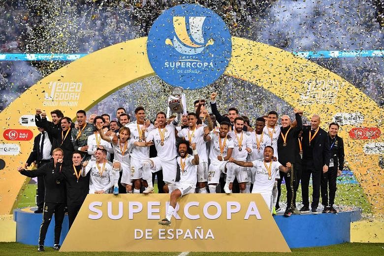 Left: Captain Sergio Ramos lifting the Spanish Super Cup while leading his Real Madrid teammates in celebrating their win over city rivals Atletico Madrid in the final on Sunday. The two teams played out a gruelling 120 minutes in Jeddah before Real 