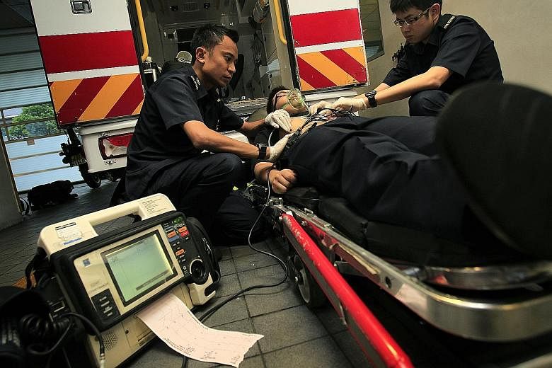 A 2011 file photo of a paramedic and a trainee demonstrating how an electrocardiogram is performed on a patient. NUH is one of just two places here which can deal with even the most complex heart problems at any time, day or night. The other is Natio