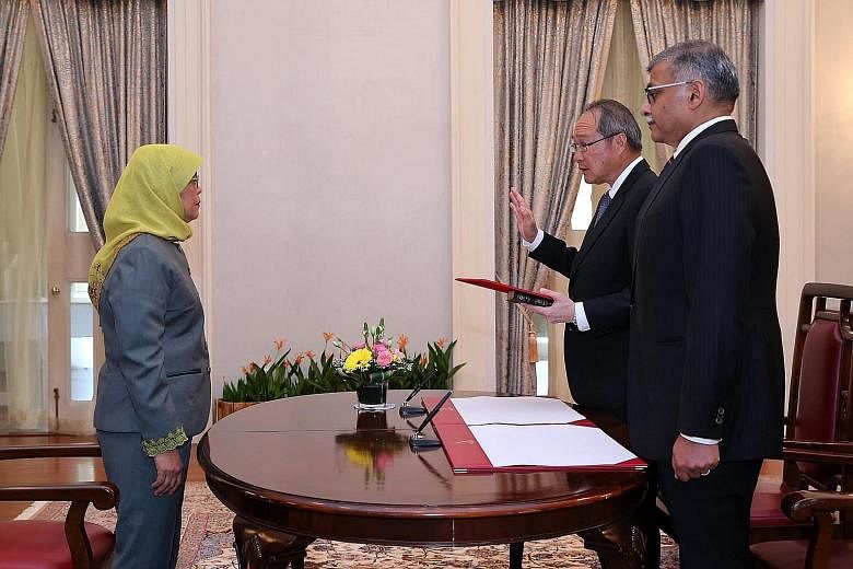 Attorney-General Lucien Wong was reappointed and sworn in at the Istana yesterday in a ceremony officiated by President Halimah Yacob. Next to him is Chief Justice Sundaresh Menon. Mr Wong, who is Singapore's ninth Attorney-General, has served as the