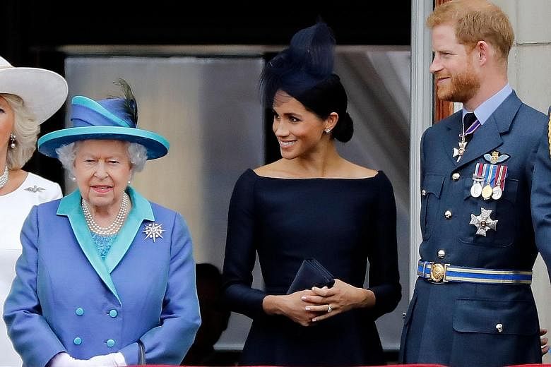 Queen Elizabeth with Prince Harry and his wife Meghan in a July 2018 photo. PHOTO: AGENCE FRANCE-PRESSE
