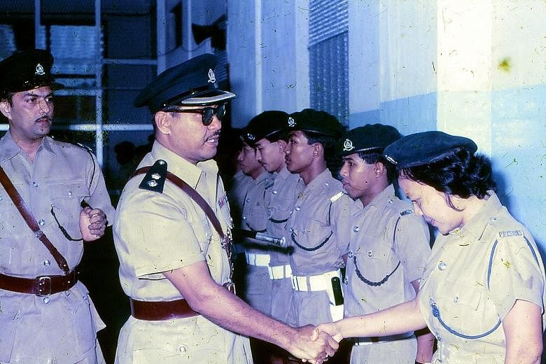 Acting Superintendent Sarpon wore sunglasses on his retirement day at Changi Prison in 1970 so no one could see his tears. Madam Norhaya Sarpon, 62, and Mr Sobahri Sarpon, 73, reminiscing with photos and stories of their late father, Mr Sarpon Muradi