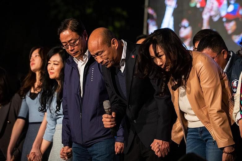 Kuomintang candidate Han Kuo-yu, surrounded by his family and party members, bowing to supporters at a rally in Kaohsiung, Taiwan, last Saturday. He received about 39 per cent of the votes. PHOTO: BLOOMBERG