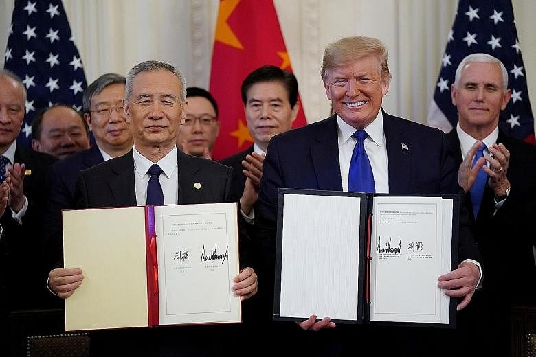 Chinese Vice-Premier Liu He and US President Donald Trump after signing phase one of the trade deal between their countries in Washington on Wednesday. The deal had China committing to buy another US$200 billion (S$269 billion) of US goods and servic