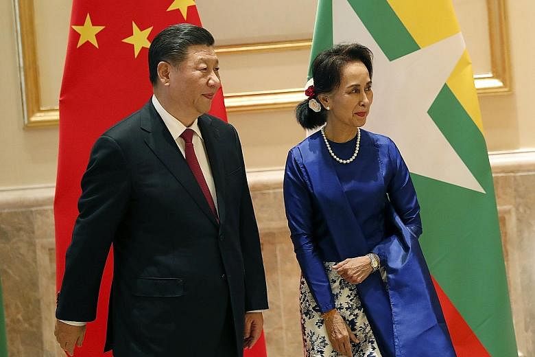 Myanmar State Counsellor Aung San Suu Kyi with Chinese President Xi Jinping at the presidential palace in Naypyitaw yesterday. Mr Xi is on a two-day visit to the country.