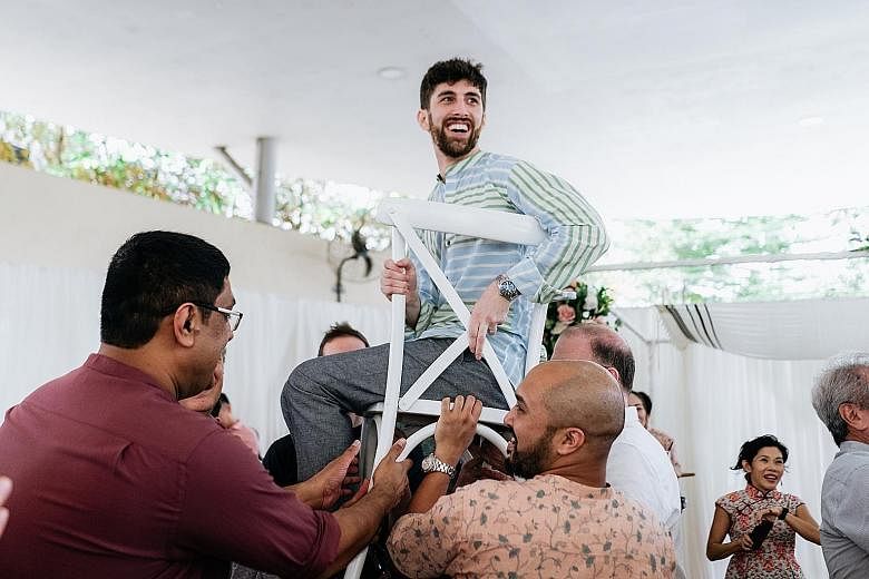 Some 150 guests, including friends and family from England, Ireland, Slovakia, Switzerland, Chicago and Los Angeles, attended the couple's Jewish-style wedding with a lion dance at a covered linkway in Clementi Avenue 4. Food from their favourite Ind