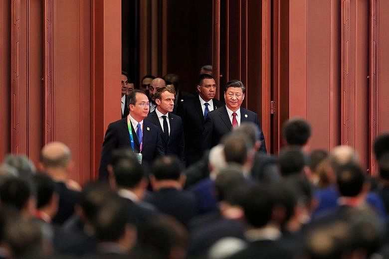 Chinese President Xi Jinping with French President Emmanuel Macron and others at the China International Import Expo in Shanghai on Nov 5 last year. While it may look like China has had to make more concessions for the US-China phase one deal, it cou