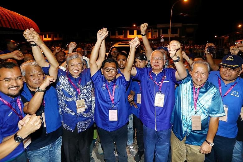 Barisan Nasional candidate Datuk Mohamad Alamin (centre) celebrating the opposition coalition's victory in Kimanis by-election in Sabah, flanked by former premier Najib Razak (right) and Umno president Ahmad Zahid Hamidi (left). PHOTO: THE STAR/ASIA 