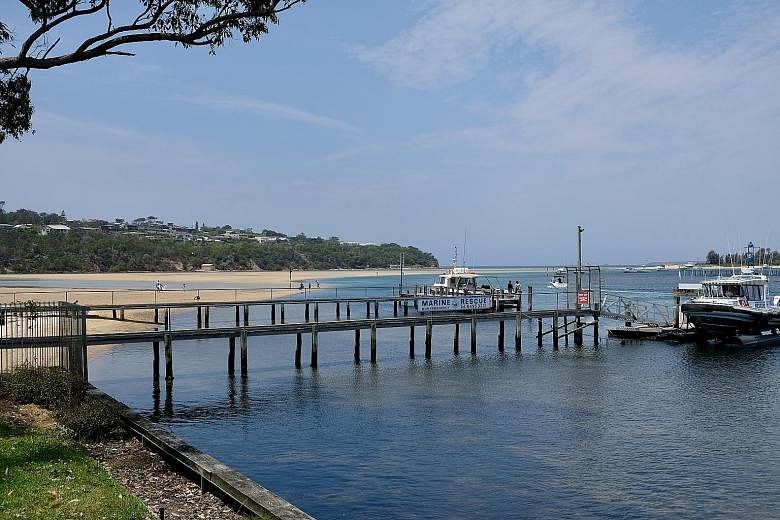 The view of the jetty from the writer’s family house in Merimbula on a clear day (above) and the house being engulfed by smoke and ash from the bushfires.