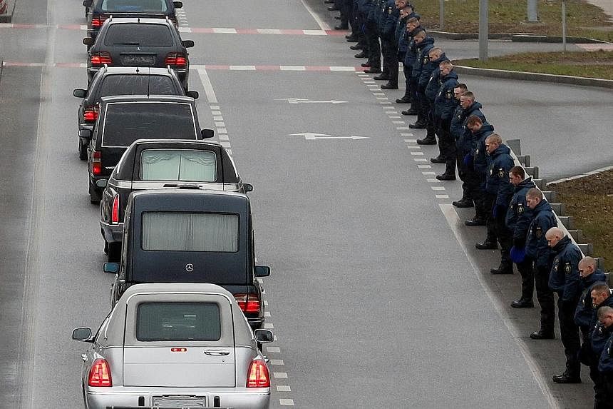A motorcade of hearses carrying the bodies of the Ukrainian victims moving along the road yesterday, ahead of the memorial ceremony at the Boryspil airport. Nine of the Ukrainians were crew members.