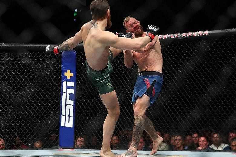 McGregor's left-footed kick to the jaw sends Cerrone reeling.