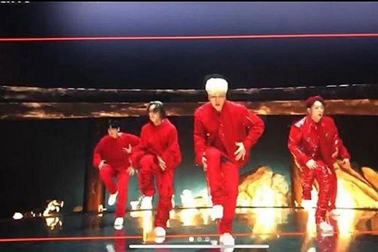 Pictures of iKON's new video show them in red outfits against a backdrop of fire, perhaps hinting at the trials they have faced in the last half year.