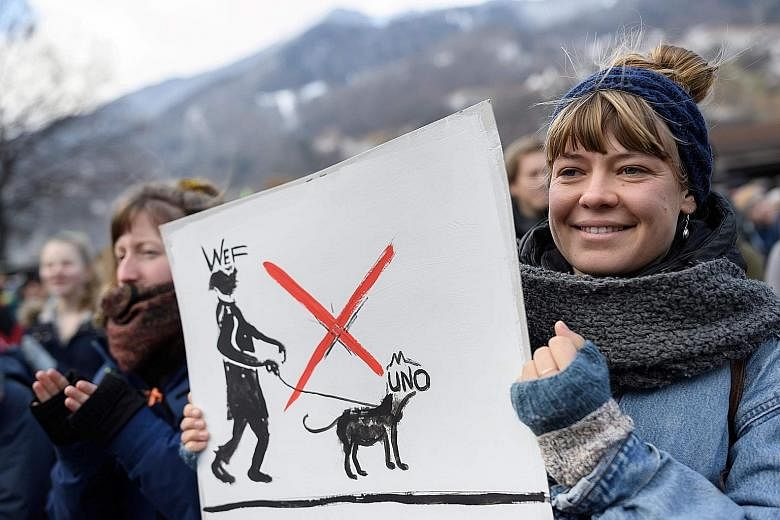 A participant at a climate activists' gathering in Landquart, Switzerland, yesterday, before the start of a march to Davos.