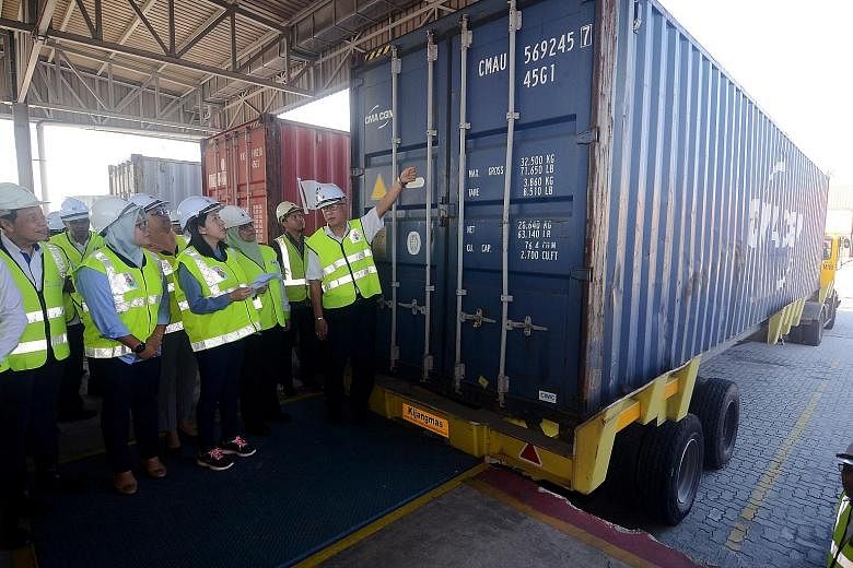 Malaysia's Energy, Science, Technology, Environment and Climate Change Minister Yeo Bee Yin (centre) at Penang Port yesterday, inspecting a container filled with plastic waste that will be returned to its country of origin.