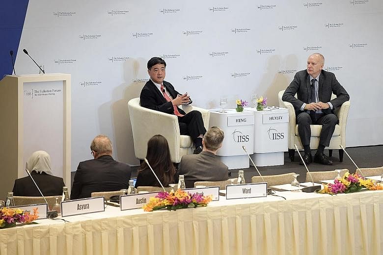 Senior Minister of State for Defence Heng Chee How speaking at the 8th IISS Fullerton Forum: The Shangri-La Dialogue Sherpa Meeting at the Fullerton Hotel yesterday, with Dr Tim Huxley, executive director of the International Institute for Strategic 