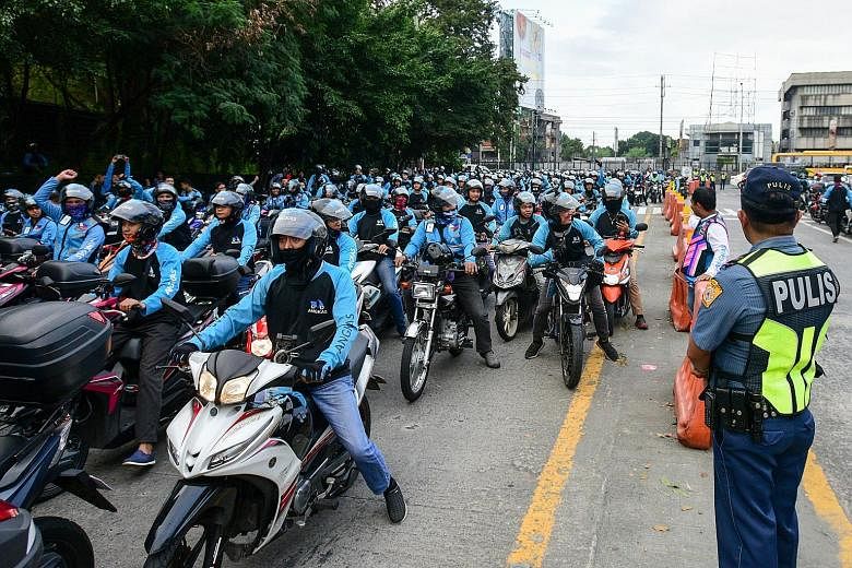 Workers for ride-hailing firm Angkas protesting in Manila last month against a transportation department directive to cut the number of riders who had signed up with Angkas from over 27,000 to 10,000. On Monday, transport officials abruptly terminate