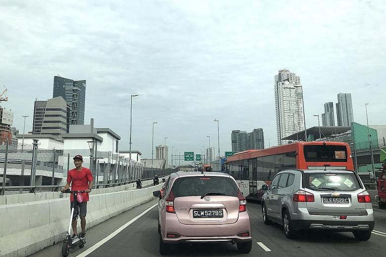 Some Malaysians who commute to work in Singapore are still riding their e-scooters into the Republic (above), but have been parking them near the Woodlands Checkpoint since the devices are banned from footpaths in Singapore. A number of workers lock 