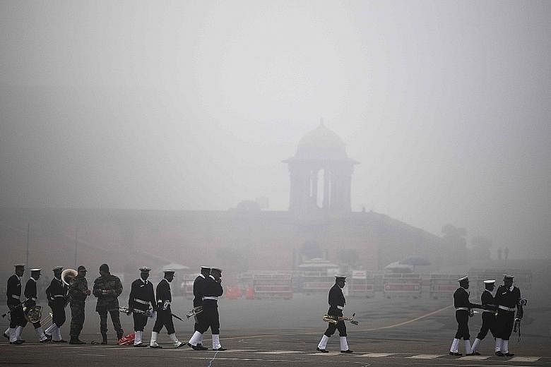The navy band preparing to rehearse for the Republic Day Parade near the Presidential Palace in smog-covered Delhi yesterday.