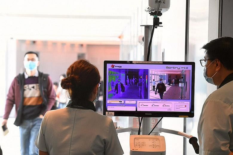A thermal scanner in use at Changi Airport Terminal 3 yesterday. Temperature screening at the airport has been expanded to cover all inbound travellers on flights arriving from China.