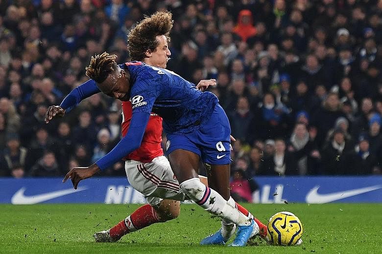 Arsenal defender David Luiz fouling Chelsea striker Tammy Abraham to concede a penalty and earn a red card on his return to Stamford Bridge on Tuesday night. Jorginho put the Blues in the lead from the spot but the Gunners equalised twice in the 2-2 