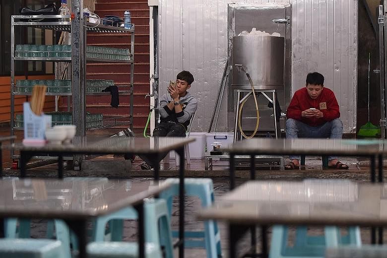 Service staff waiting for customers at a Hanoi bar yesterday. A tough new drink-driving law is part of an effort to change the drinking culture in Vietnam, one of the world's fastest-growing markets for beer. PHOTO: AGENCE FRANCE-PRESSE