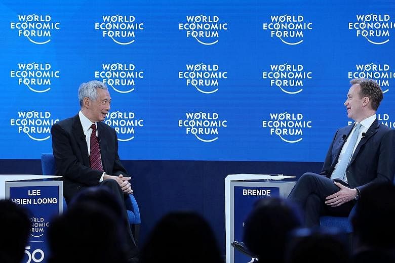 Prime Minister Lee Hsien Loong in a dialogue with World Economic Forum president and former Norwegian foreign minister Borge Brende in Davos yesterday. PHOTO: MCI