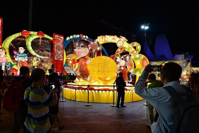 A lantern showcasing this year's animal according to the Chinese zodiac - the Rat. Wind percussion ensemble Reverberance took the stage at last night's opening ceremony. A towering lantern of Cai Shen Ye, the God of Wealth, at the floating platform. 