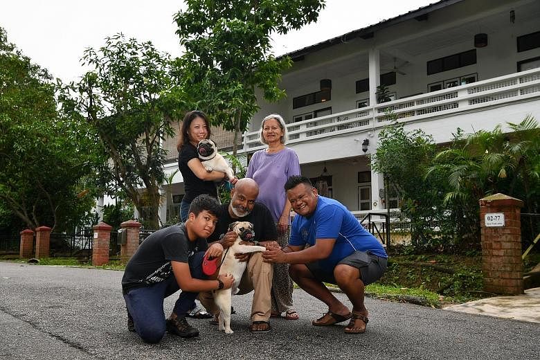 Jalan Hang Jebat residents Jean-Luc Amerasinghe (left, front row), with his father Brian Amerasinghe, neighbour David Santhanansamy, Mr Santhanansamy's wife Esther Jane De Rozario, and Mr Amerasinghe's wife Iris Tan Lay Lan, outside their houses with