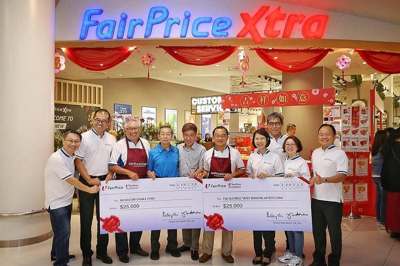 The Business Times Budding Artists Fund and the Mediacorp Enable Fund each received a $25,000 donation from NTUC FairPrice yesterday. PHOTO: LIANHE ZAOBAO