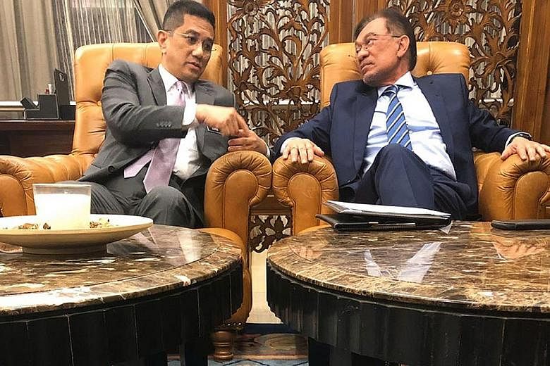 PKR deputy president Mohamed Azmin Ali (above, left) and president Anwar Ibrahim in a file photo. They are engaged in a bitter feud, with the latest incident involving party vice-president Zuraida Kamaruddin (left). PHOTOS: MALAYSIAKINI, THE STAR/ASI