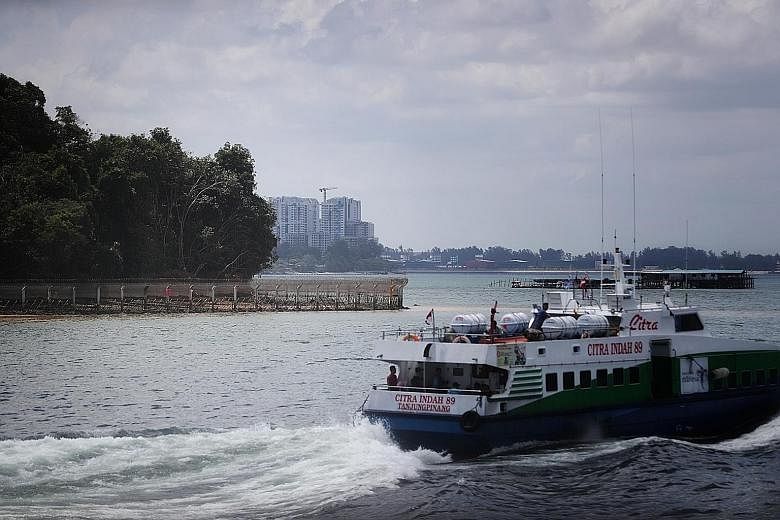 The police say that along with floating sea barriers, fences - such as the sea-based fencing near Pulau Ubin visible in the background of this photo - are critical to Singapore's security.