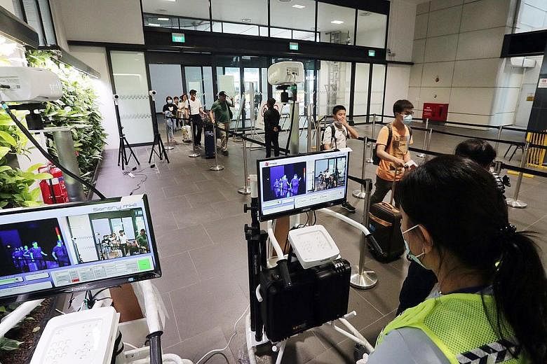 Temperature screening stations have been set up at Tuas (above) and Woodlands checkpoints. The Health Ministry stressed that all measures will be taken to contain the possible spread of the Wuhan virus. ST PHOTO: KELVIN CHNG