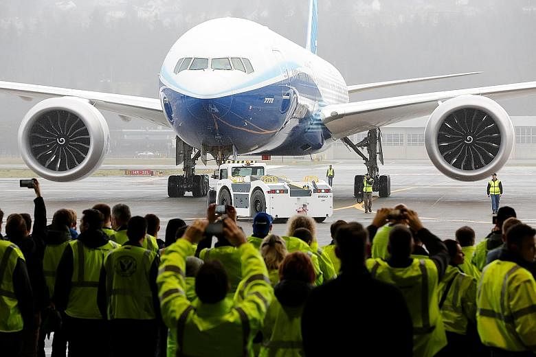 A Boeing 777X plane - the world's largest twin-engine jetliner, which can seat 406 - returning to a hangar after its first test flight at the company's facility in Seattle, Washington, last Saturday.