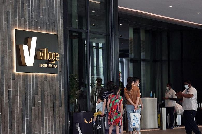 Hotel guests and staff wearing masks yesterday at Village Hotel Sentosa, where Singapore's fourth confirmed case of the Wuhan coronavirus infection - a Chinese national from Wuhan - had been staying. ST PHOTO: TIMOTHY DAVID