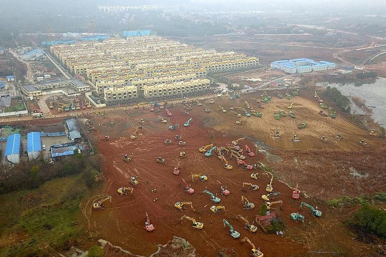 Excavators and bulldozers on Friday at a construction site on the outskirts of Wuhan where a hospital is being built to treat patients affected by the new coronavirus. It is due to be completed by Feb 3. A second dedicated hospital to treat such pati