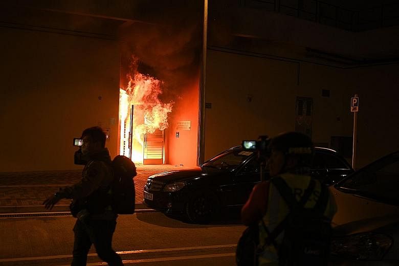 An entrance to an empty public housing block in Hong Kong's Fanling district on fire on Sunday as demonstrators threw petrol bombs in protest against a plan to turn the estate into a quarantine zone.