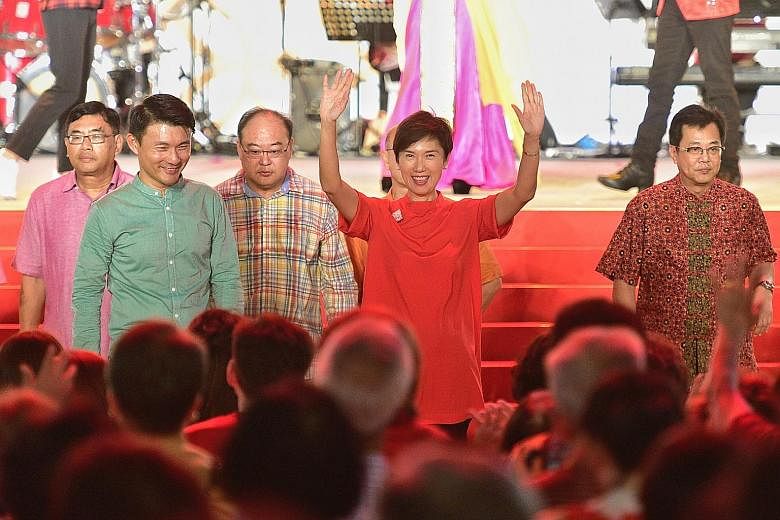Minister for Manpower and Second Minister for Home Affairs Josephine Teo greeting crowds at the River Hongbao event at The Float@Marina Bay last night. With her was Senior Parliamentary Secretary for Transport, and Culture, Community and Youth, Mr Ba